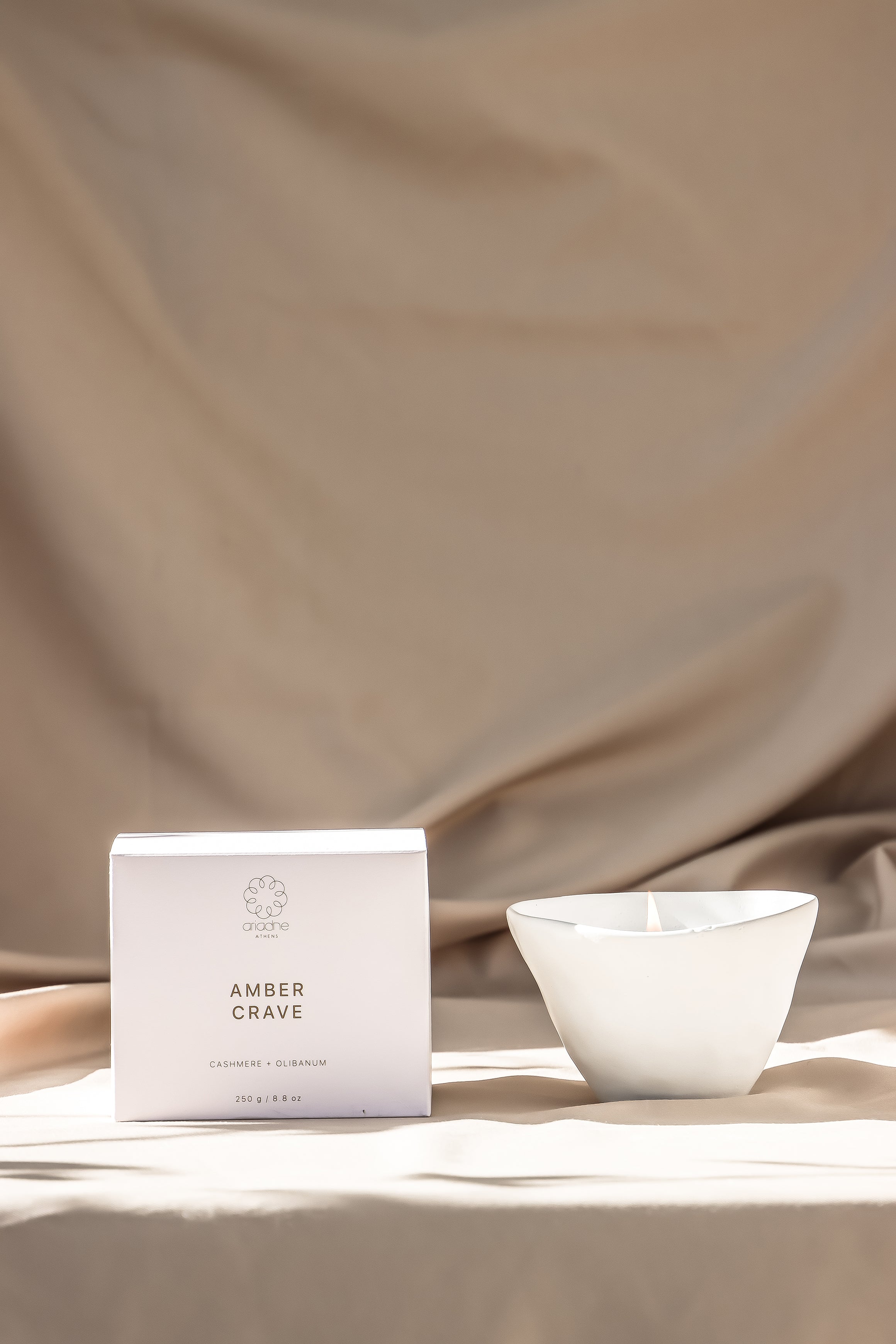 An amber crave candle with its packaging